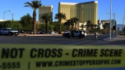 Crime scene tape surrounds the Mandalay Hotel (background) after a gunman killed at least 50 people and wounded more than 200 others when he opened fire on a country music concert in Las Vegas, Nevada on October 2, 2017.
Police said the gunman, a 64-year-old local resident named as Stephen Paddock, had been killed after a SWAT team responded to reports of multiple gunfire from the 32nd floor of the Mandalay Bay, a hotel-casino next to the concert venue. / AFP PHOTO / Mark RALSTON (Photo credit should read MARK RALSTON/AFP/Getty Images)