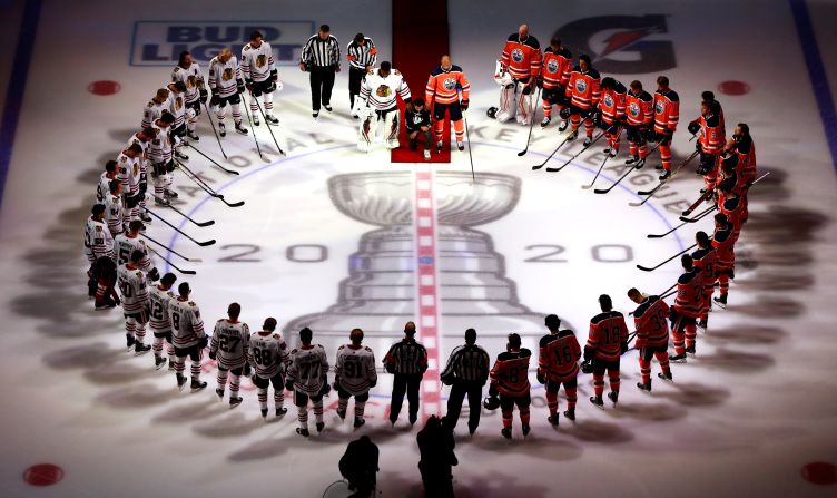 Matt Dumba of the Minnesota Wild <a href="index-1026.html" target="_blank">kneels during the US National Anthem</a> as it is played before an NHL game in Edmonton, Alberta, on August 1. Dumba, a member of the Hockey Diversity Alliance, gave a short speech before kneeling. He is circled by members of the Edmonton Oilers and the Chicago Blackhawks, who were about to play on the first day of the NHL's return.