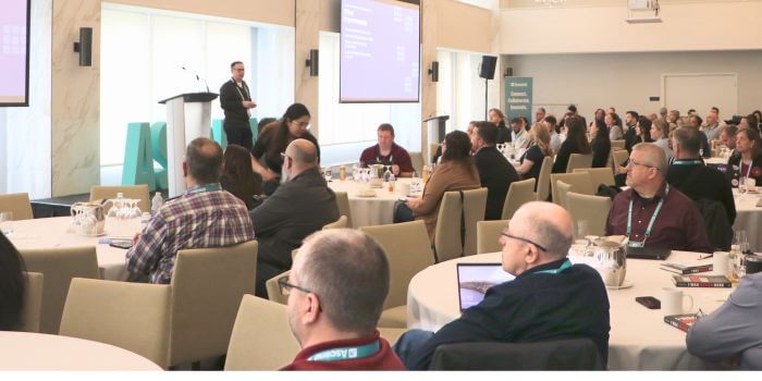 Jamie burr presenting resolver’s ai intake and triage for incident management to attendees at ascend 2025, highlighting new automation features.