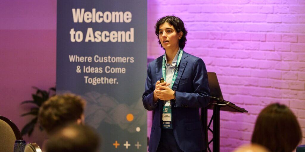 Alexia konstantinidi of kroll delivers a keynote on ai and cyber risk at ascend grc london 2025, hosted by resolver. A banner behind her reads “welcome to ascend – where customers & ideas come together. ”