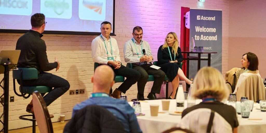 Risk and compliance leaders speak on a customer panel at ascend grc london 2025, hosted by resolver, with audience members listening.