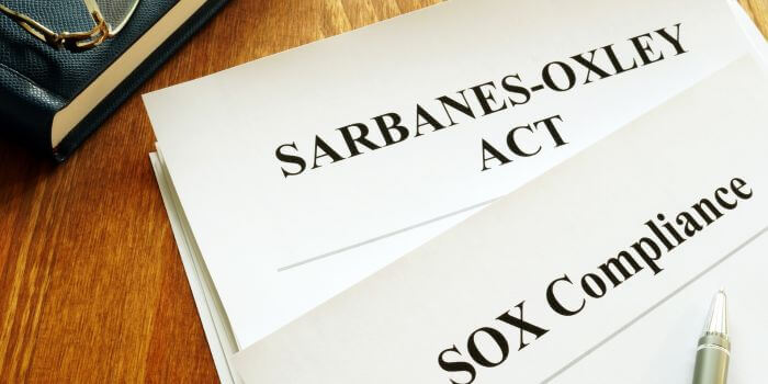 Documents titles sarbanes-oxley (sox) act & sox compliance on a desk representing internal audits and sarbanes-oxley